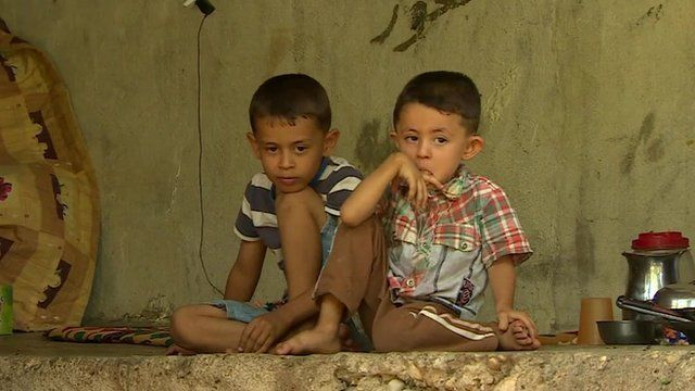 Yazidis children sat on wall
