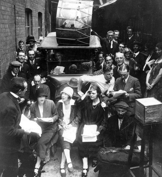 Tyrone Guthrie in bow tie and white shirt making an outside broadcast in Linenhall Street in 1928