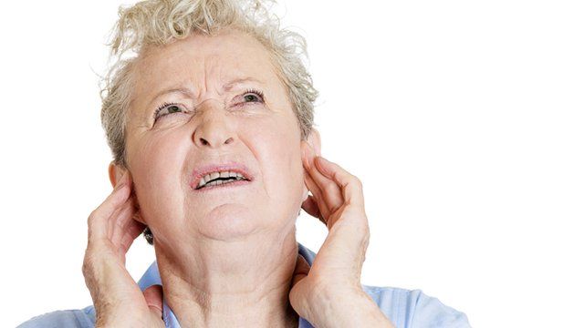Woman puts fingers in her ears