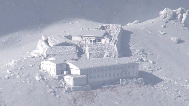 Buildings near Mount Ontake are covered in volcanic ash