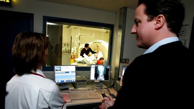 David Cameron watches a patient having an X-ray