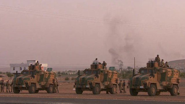Turkish tanks face away from Syria border town Kobane