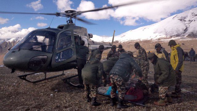 Injured survivor with Nepalese army