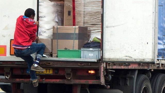 An illegal migrant steps into a truck