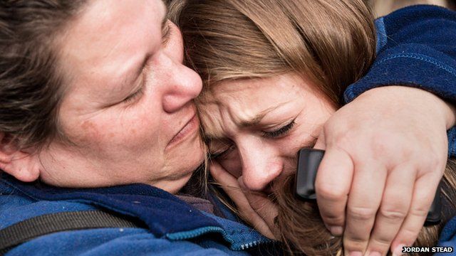 A tearful Marysville Pilchuck High School senior, Cassandra LaBrake, right, is safely reunited with her mother Shellie LaBrake, left, near the scene of the school shooting at Marysville Pilchuck High School in Marysville