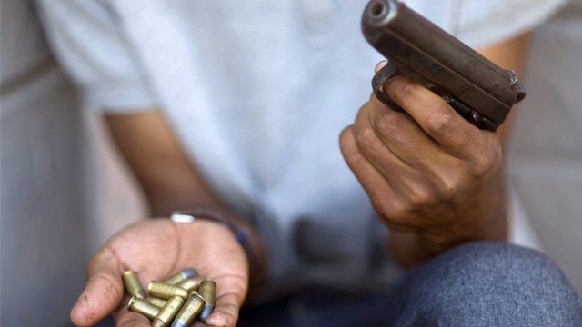 South African gang member holds gun