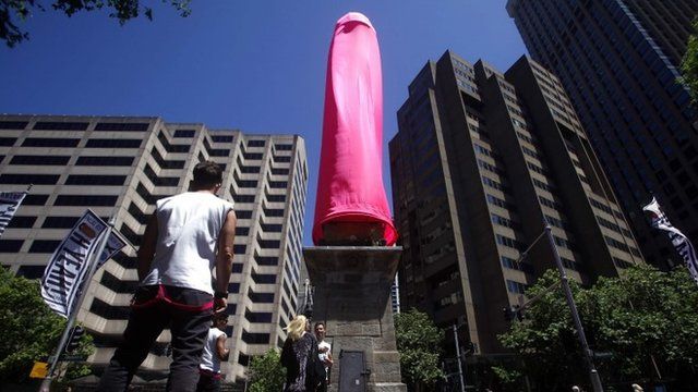 Man looks at giant condom in Sydney
