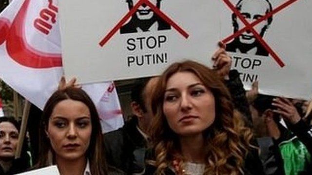 Supporters of the United National Movement Party hold anti-Putin placards during an anti-Russia rally, Tbilisi, Georgia
