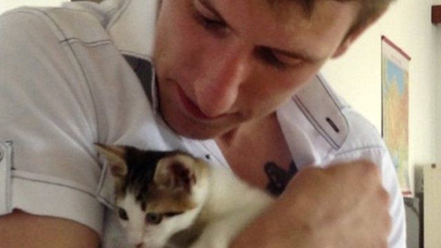 In this undated photo provided by the Kassig Family, Peter Kassig, is shown with an injured kitten, which was rescued and nursed back to health by Kassig and a friend