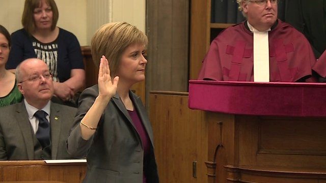 Nicola Sturgeon with hand raised to take oath