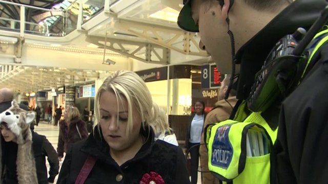 British transport policeman speaking to a member of the public