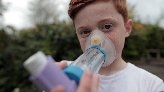 Boy using asthma inhaler