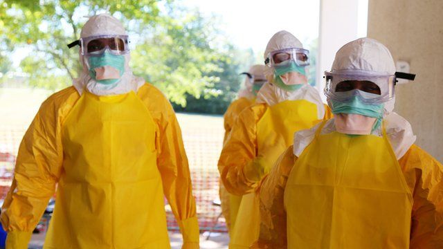 Staff in personal protective equipment to shield against Ebola