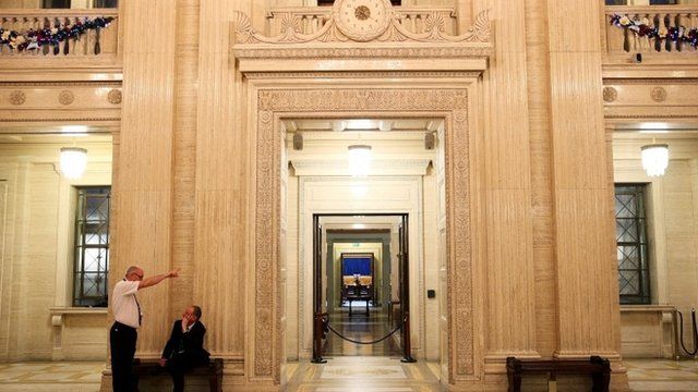 5People wait in the Great Hall at Parliament Buildings, Stormont, as political talks continue in Stormont House