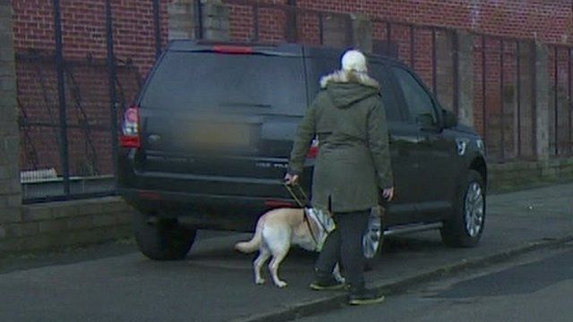 Blind person with guide dog blocked by car on pavement
