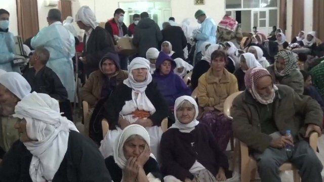 Released Yazidis in a room with medical staff