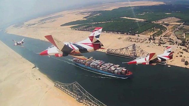 Planes fly over ship on Suez Canal