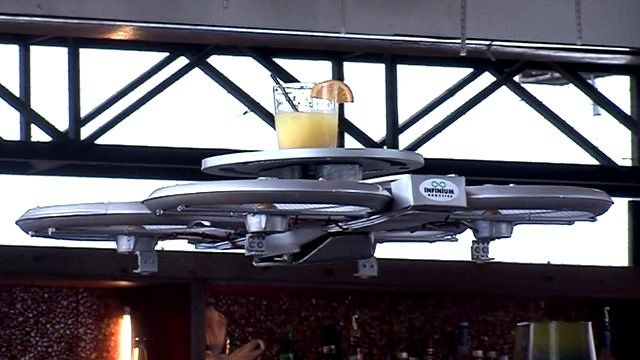 Drone waiter carries drink