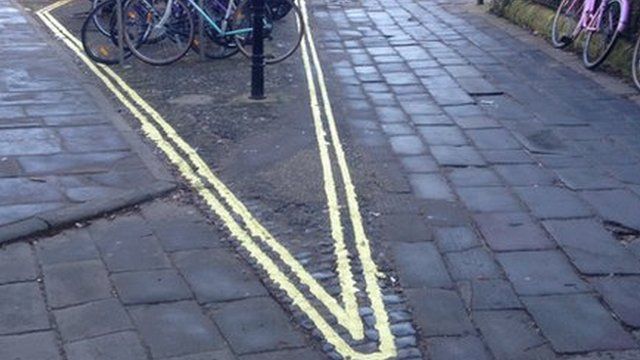 Double yellow lines around a bicycle bay