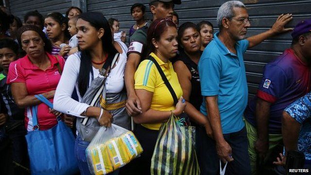 Shoppers line up to buy basic items in downtown Caracas