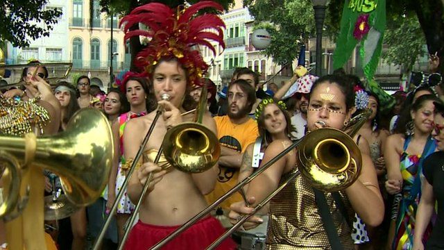 A women's brass band plays during a carnival parade