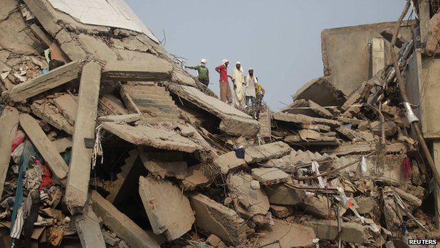 Rescue workers look for trapped garment workers at the collapsed Rana Plaza on 26 April 2013