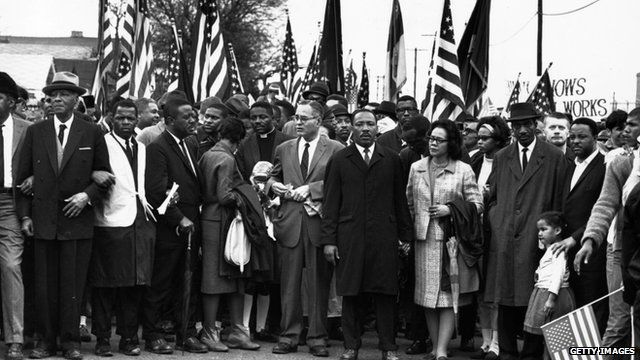 Civil rights campaigner Dr Martin Luther King (C) with his wife Coretta Scott King, at a black voting rights march in Selma in March 1965