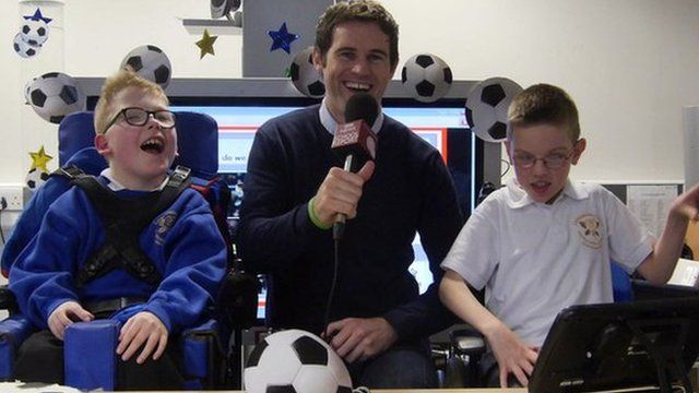 Kevin Kilbane works with School Reporters Ben and Sam