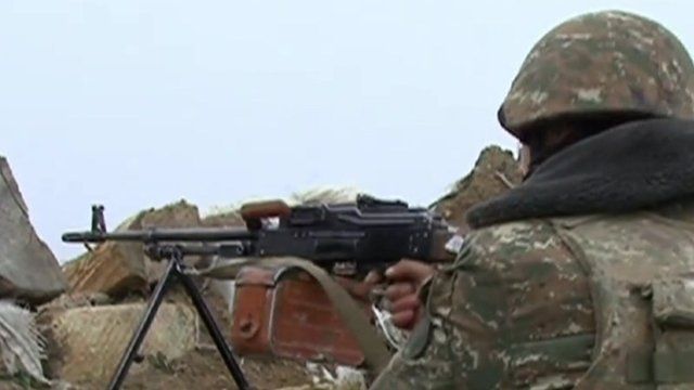 Soldier in Nagorno-Karabakh aiming gun