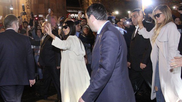 Kim and Khloe Kardashian with minders greet the crowd