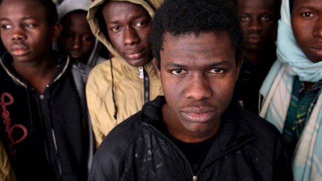 Illegal migrants stand in an immigration holding centre located on the outskirts of Misrata Libya, March 11, 2015.
