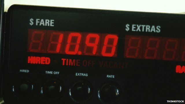 A taxi meter shows a fare without any 'extras' charged