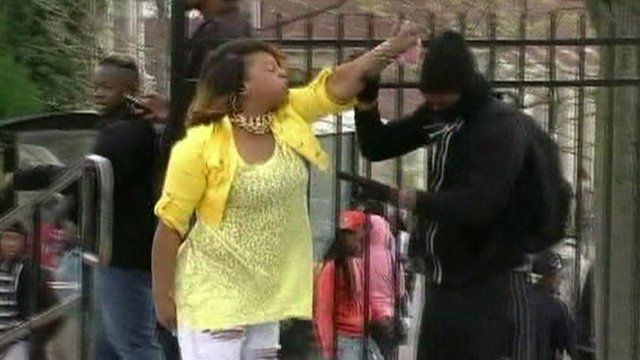 Woman hitting man dressed in black