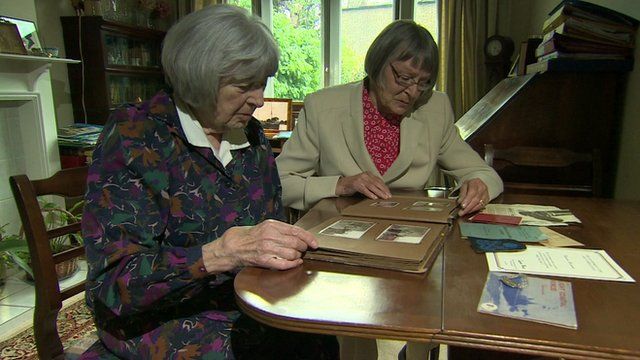 Sisters Pat Davies and Jean Argles looking at archive photos