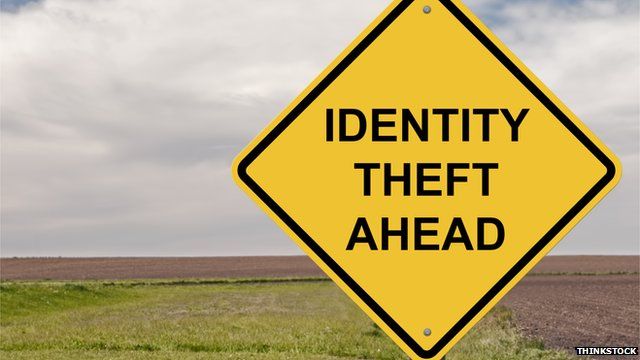 A road sign reads 'identity theft ahead'