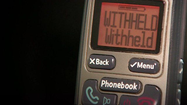Close up of mobile phone screen showing message "Withheld withheld"