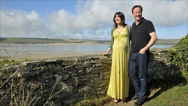 British Prime Minister David Cameron accompanied by his wife Samantha