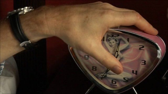 Man grabbing alarm clock