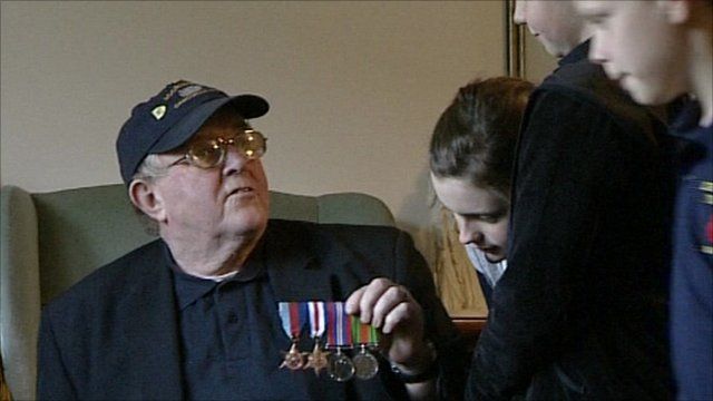 Veteran showing war medals