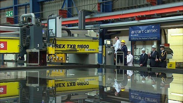 Defence Secretary Liam Fox cuts the first steel in the shipyard