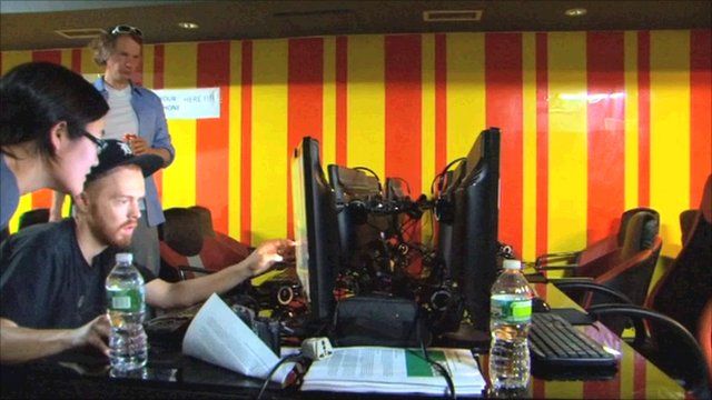 Evan Roth looking at a computer monitor