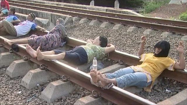 People lying down on a railway track
