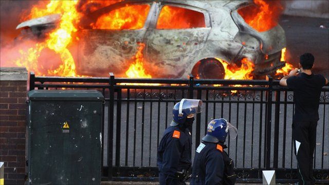 Police stand near burning car in Birmingham