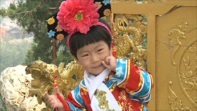 Child poses at tourist attraction marking the revolution