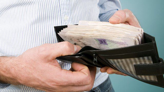 Man with cash in his wallet