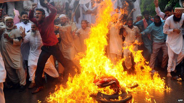 Protesters in Pakistan set fire to an American flag