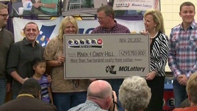 Mark and Cindy Hill holding cheque