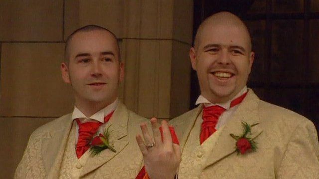 Male same-sex couple showing off wedding ring