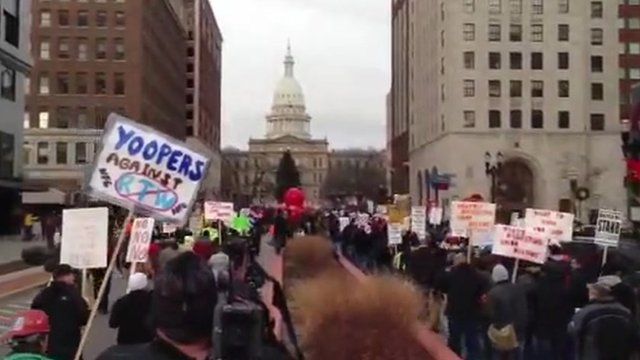 Protesters walk to Michigan state house
