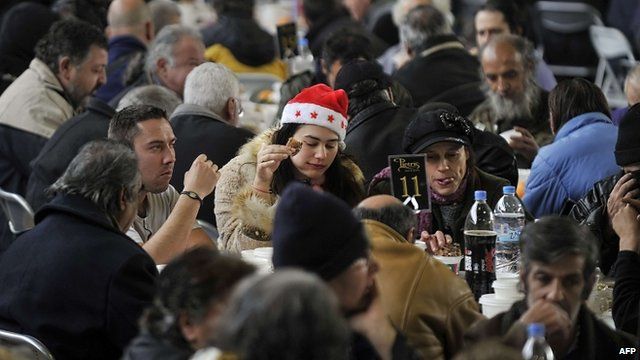 Homeless people are served a New Year's dinner offered by the municipality of Athens